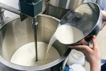 Stirring sour cream. Production of dairy products, butter and sour cream. Stirring sour cream. Production