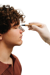 Surgeon drawing markup on nose before rhinoplasty surgery. Preparation for septoplasty and...