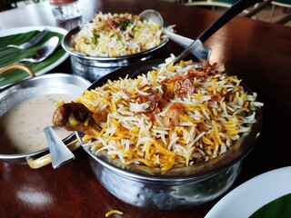 Indian cuisine - Kolkata biryani made with basmati rice, chicken, boiled egg and potato.