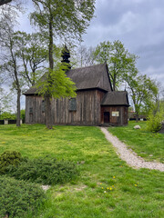 Obraz premium Old wooden church next to the only archcollegiate in Poland Archcollegiate of the Blessed Virgin Mary and St. Alexego in Tum (Leczyca Archcollegiate) – a church built in the 12th century in Leczyca