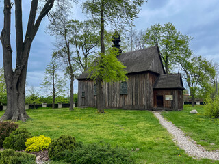Obraz premium Old wooden church next to the only archcollegiate in Poland Archcollegiate of the Blessed Virgin Mary and St. Alexego in Tum (Leczyca Archcollegiate) – a church built in the 12th century in Leczyca