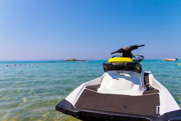 The motorboat, a sleek vessel with a powerful engine, is gracefully navigating the calm, cerulean...