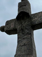 An old stone cross at the collegiate church in Tum with a Polish inscription 