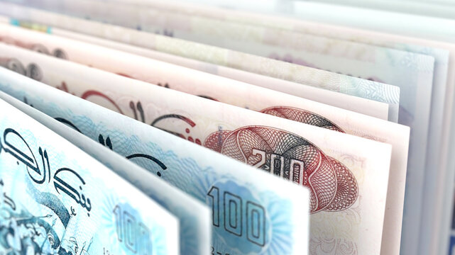 Close-up view of Algerian dinar banknotes in various denominations.