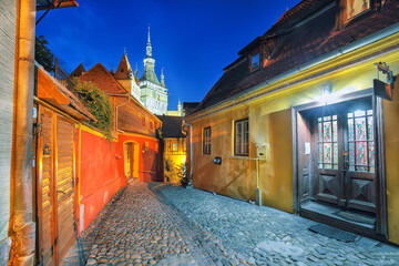 Amazing night view of historic town Sighisoara and Clock Tower built by Saxons.