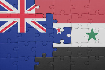 puzzle with the colourful national flag of syria and flag of new zealand.