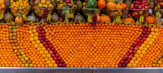 Large fruit shop. A stall with a variety of oranges and other fruits.
