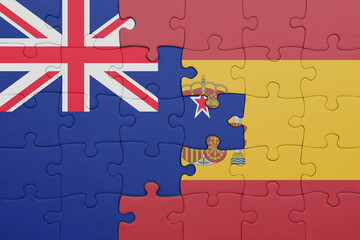 puzzle with the colourful national flag of spain and flag of new zealand.