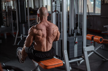 Caucasian man doing rowing exercises on a rowing machine. 