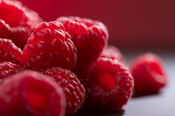 Raspberry fresh berries closeup, ripe fresh organic Raspberries over dark background, macro shot. Harvest concept, border design 