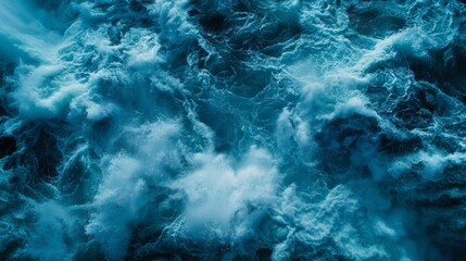 Aerial view of turbulent waves in deep blue water creating a textured aquatic pattern.