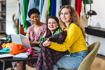 Group of young women creating small modern business start up, project for fashion design, clothes creation. Concept of people at work, purchasing and online shopping. Friends learning, college life
