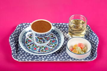 Turkish coffee on pink background. Summer themed Turkish coffee on  pink paper background. freshly cooked Turkish coffee and Turkish Delight.