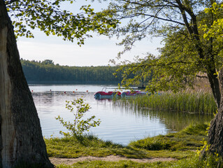 Scenic view at Strzeszynek lake (Jezioro Strzeszyńskie), recreational beach area near Rusałka lake in Poznan, Poland. Boats (catamarans) resting in the pond. © uslatar