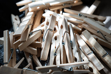 A Closeup Of A Large Pile Of Clothespins Pegs On A Black Table For Drying Clothes