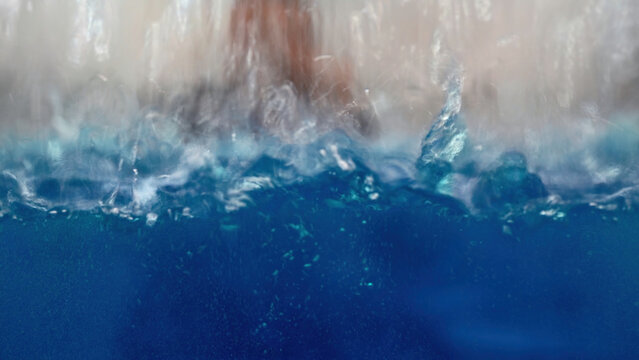 industrial background with a transparent reservoir being filled with liquid. Media. Water drops falling down and making ripples.