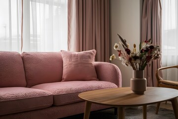 Elegant pink sofa, wooden coffee table, chair, dried flowers, soft pink curtains