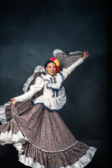Fototapeta premium A woman in a colorful dress is dancing