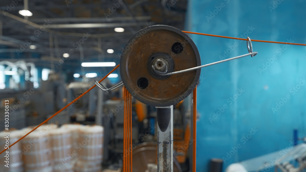 Poster industrial machine with rotating coils and wire. creative. system with coils of tensioning wires on 
