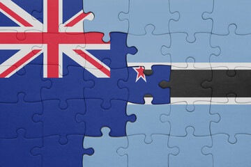 puzzle with the colourful national flag of botswana and flag of new zealand.