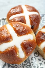 Tasty hot cross buns on table, closeup