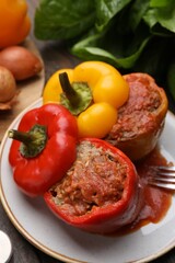 Delicious stuffed bell peppers served on wooden table