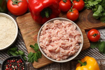Making stuffed peppers. Ground meat and other ingredients on wooden table, flat lay