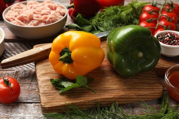 Making stuffed peppers. Ground meat and other ingredients on wooden table