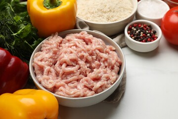 Making stuffed peppers. Ground meat and other ingredients on white marble table