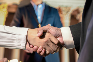 business people shaking hands, handshaking between professionals, collaboration deal