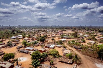 Obraz premium Aerial view of a rural town with a dusty road nearby