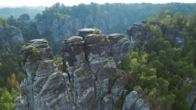 Scenic aerial perspective of Saxon Switzerland with rock formations and green pine tree forest. Bastei mountains, Germany.