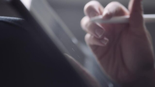 Graphic artist using a tablet to create a drawing with a pen. Slow motion. 