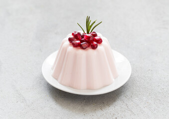 Italian dessert. Pomegranate Panna Cotta  On a plate. Close-up