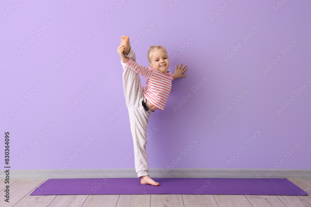 Poster Cute little girl practicing yoga on mat against lilac background