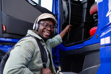Happy truck driver listening to music and entering truck vehicle.