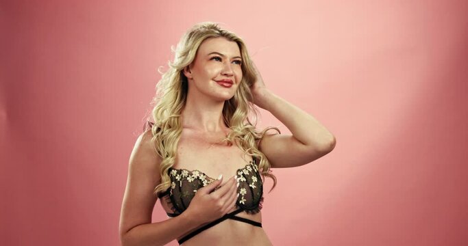 Happy woman, lingerie and satisfaction with beauty, seduction or sexual desire on a studio background. Female person, model or blonde with underwear in relaxation, provocative temptation or pleasure