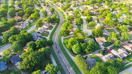 Concrete channels S curved shaped facilitates drainage from residential streets discharge into creeks, flood storage capacity to waterway section drains in Coppell, suburbs Dallas, Texas, aerial