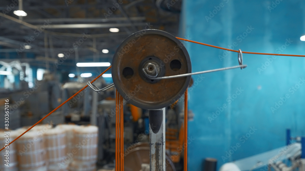 Poster industrial machine with rotating coils and wire. creative. system with coils of tensioning wires on 