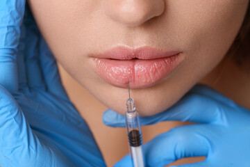 Woman receiving lip injection, closeup