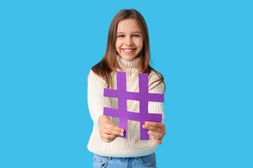 Cute teenage girl with hashtag on blue background