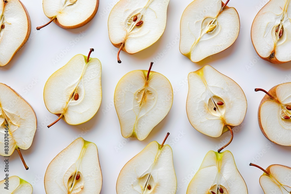Poster a close up of a bunch of pears with the stem still attached. the pears are cut in half and arranged 