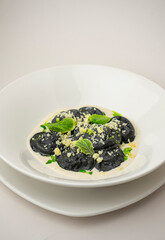 Black ravioli on a white background