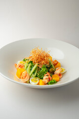 Warm shrimp salad on a white background