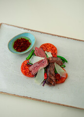 Striploin with grilled vegetables on a white background