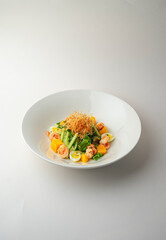 Warm shrimp salad on a white background