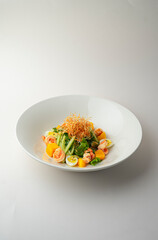 Warm shrimp salad on a white background