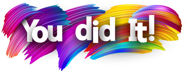 You did it paper word sign with colorful spectrum paint brush strokes over white.
