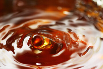 Macro shot of tea drink ripples as background