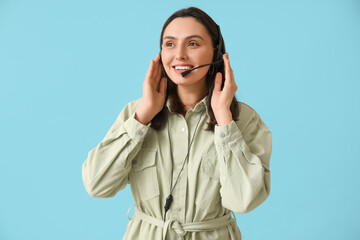 Female technical support agent in headset on blue background